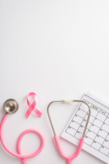 Breast cancer awareness concept. Top view vertical photo of pink silk ribbon stethoscope and...