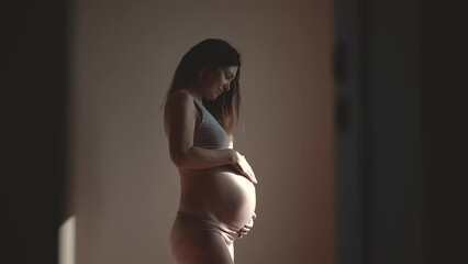 pregnant woman. health pregnancy motherhood indoors procreation concept. close-up belly of a pregnant woman. woman waiting for a newborn baby. pregnant woman holding her belly sunlight - Powered by Adobe