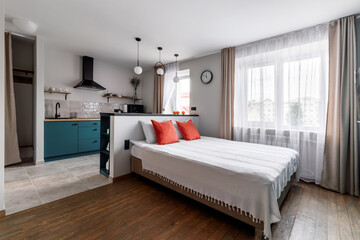 White pillows, duvet and duvet case on a blue bed. White bed linen on a blue sofa. Bedroom with bed...