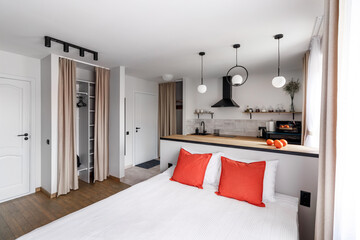 White pillows, duvet and duvet case on a blue bed. White bed linen on a blue sofa. Bedroom with bed...