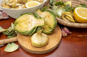 Cooking of green heads of artichokes plants, how to peel artichoke