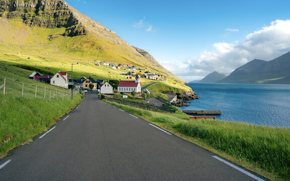 Traditional Faroe village of Kunoy with picturesque church and mountain