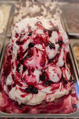 Assortment of colorful artisanal ice cream in refrigerator close up in Spain