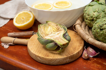 Cooking of green heads of artichokes plants, how to peel artichoke