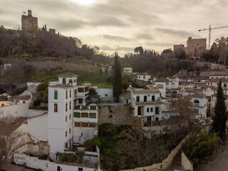 Aerial panoramic view on buildings, old district, mountains and Alhambra palace, world heritage city Granada, Andalusia, Spain