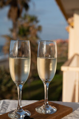 Glasses of Spanish cava sparkling wine and view on blue sea and sandy beach, Costa del Sol vacation destination, Andalusia, Spain
