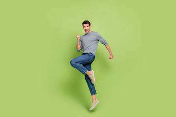 Full body photo of attractive carefree good mood man jumping in excitement triumph isolated on...
