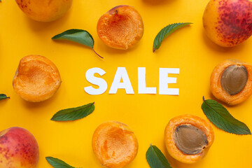  apricots and leaves with paper words. Sale on orange paper