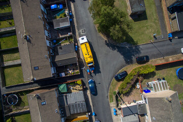 aerial view of refuse collecting lorry collecting domestic rubbish from homes using the wheelie bin system, City waste manage and recycling  