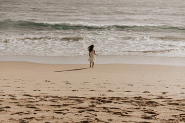 Fototapeta na wymiar Lonely kid walking towards sea