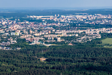 ariel panoramic view of city and skyscrapers with a huge factory with smoking chimneys in the background