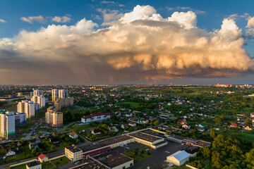 ariel panoramic view of city and skyscrapers with a huge factory with smoking chimneys in the background