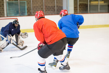 Ice hockey players playing ice hockey in the ice rink in winter