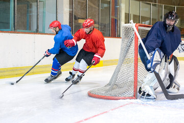 Ice hockey players playing ice hockey in the ice rink in winter