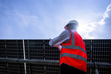 Businessman on a tour of solar power plants to check the operation of the power generation system....