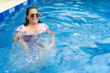 Senior woman relaxing in swimming pool