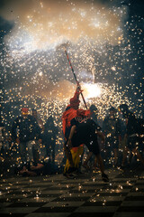 correfoc canovelles, people dancing around devil carrying fireworks in catalonia spain