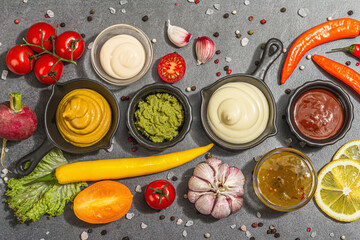 Set of sauces and fresh vegetables. Ketchup, mustard, mayonnaise, wasabi, sweet curry, and BBQ