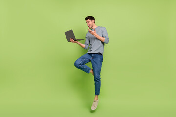 Full body photo of cheerful businessman have video meeting with his colleagues isolated on green color background