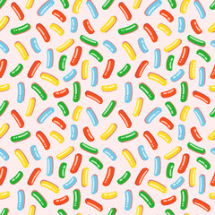 Seamless pattern with pink icing for donuts with lots of decorative bright sprinkles. Vector illustration of colorful candy sprinkles for fabrics, textures, wallpapers, posters, cards.