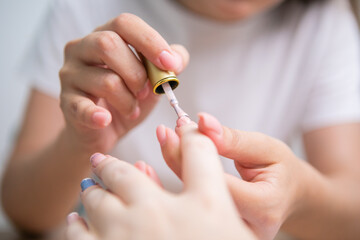 Nail Care And Manicure. Closeup Of Beautiful Female Hands Applying Nail Polish On Healthy Natural Woman's Nails In Beauty Salon.