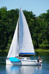 Sailboat swimming on a lake - side view