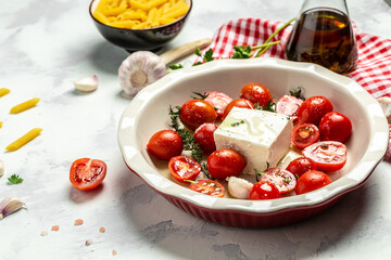 cooking viral Feta bake pasta with roasted cherry tomatoes, cheese, herbs and garlic. menu recipe place for text, top view
