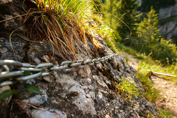 Some chains placed on a rock in a mountain hiking trail used as safety measure for the mountaineers...