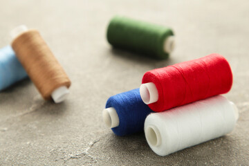 Color sewing threads on grey background
