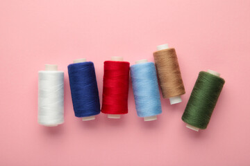 Color sewing threads on pink background