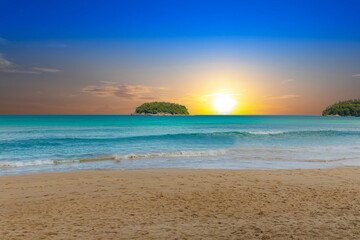 Fototapeta na wymiar Colourful Skies Sunset over Kata Beach in Phuket Thailand. This Lovely island waters are turquoise blue waters, lush green mountains colourful skies and beautiful views of Pa Tong Patong