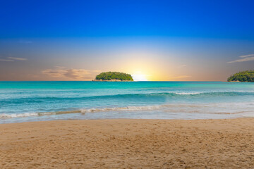Fototapeta na wymiar Colourful Skies Sunset over Kata Beach in Phuket Thailand. This Lovely island waters are turquoise blue waters, lush green mountains colourful skies and beautiful views of Pa Tong Patong