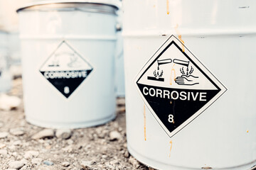 The empty tin bucket inscribed with a corrosive sign