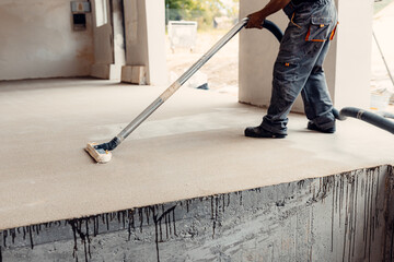 A closeup shot of a worker preparing floor for painting