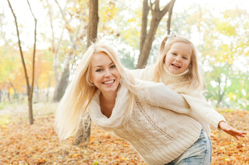 Happy joyful family, mother and daughter have a rest outdoor
