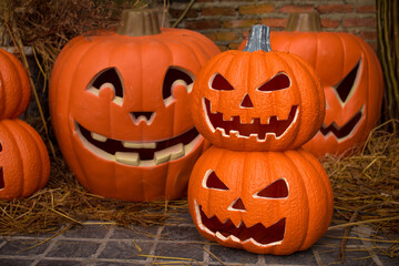 Craved pumpkin head jack lantern put on rice straw in Halloween theme.