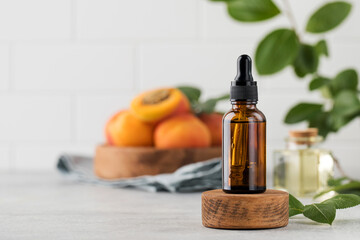 Glass dropper with skin serum with apricot seed extract. Cosmetics with natural ingredients. 