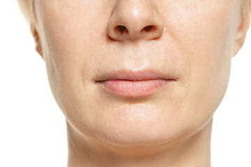 Close-up portrait of middle-aged woman's lips. Model isolated on white. Mimic wrinkles.