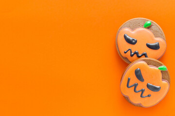 Bright gingerbread cookies for Halloween party on an orange backgound. Orange pumpkin cookies. Copy space. Top view.