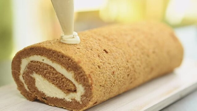 Decorating pumpkin roll with candied ginger.
