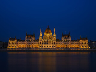 Parliament building in Budapest, Hungary. Parliament and reflections in the Danube River. Evening illumination of the building.