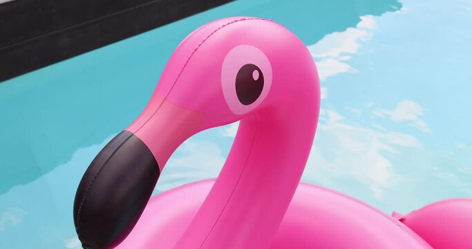 Vacation travel concept with inflatable pink flamingo float toy mattress