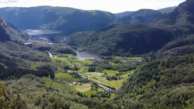 Flight over the mountains. The nature of Norway goths and the village at the bottom of the valley near the river and fjord