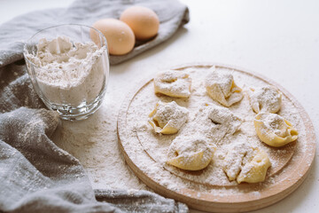 Making tortellini home, handmade, on kitchen worktop