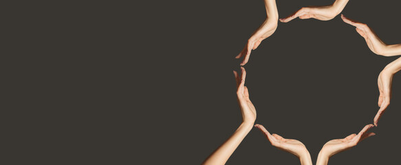 Many hands making frame on dark gray background