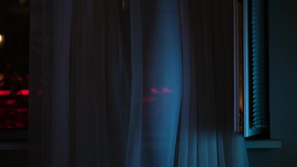fan on the window creates a flow of fresh air. window with the background of the night