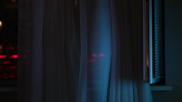 fan on the window creates a flow of fresh air. window with the background of the night