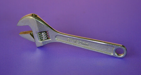 adjustable wrench isolated on purple background