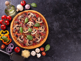 Mushroom pizza with ingredients on black background