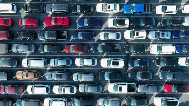 Top down aerial of cars parked in tight spaces. Manheim auto auction. Sedans, SUVs, and trucks stuck in parking spots.